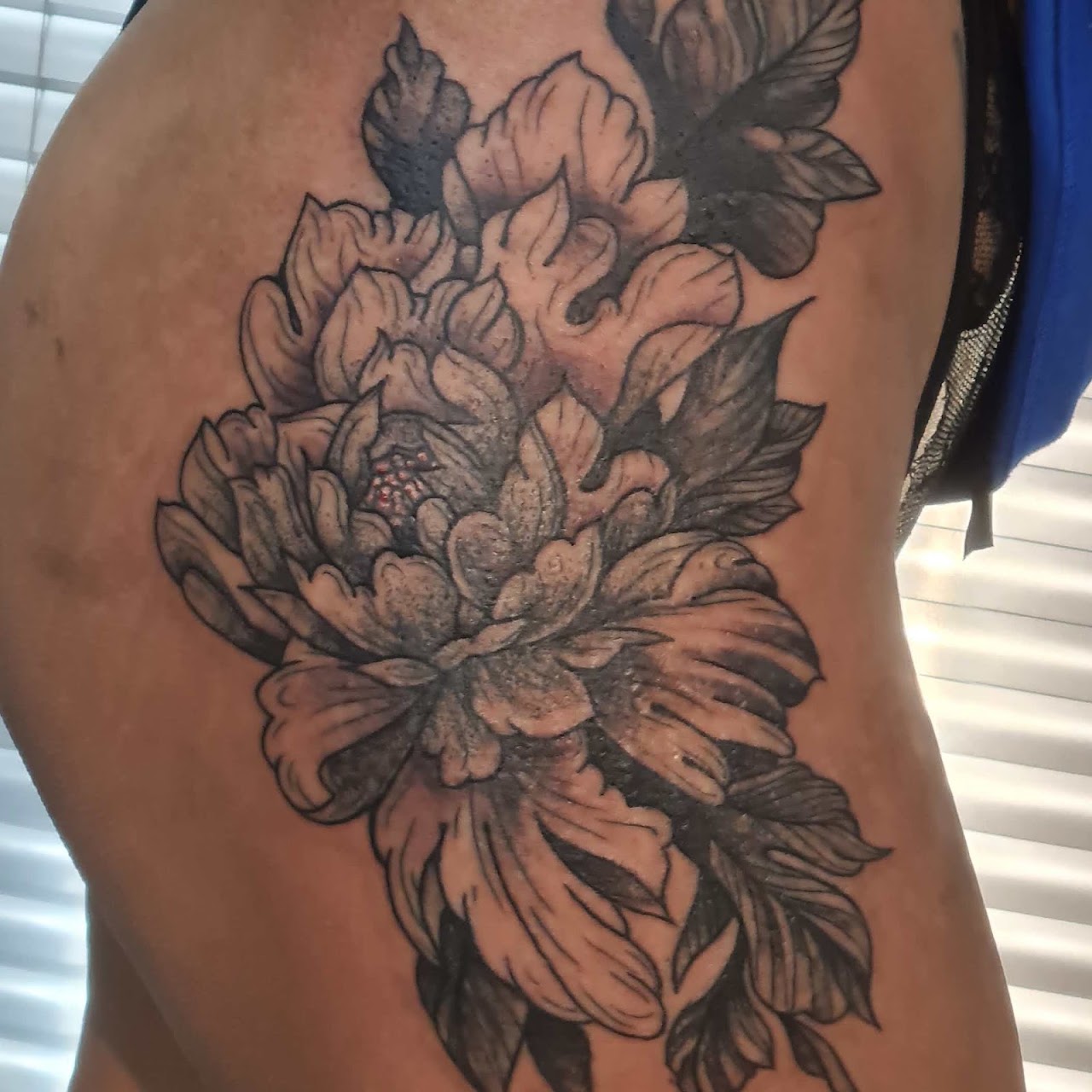 Tatuaje floral de peonía en negro y gris hecho en Kito Bianchi Tattoo